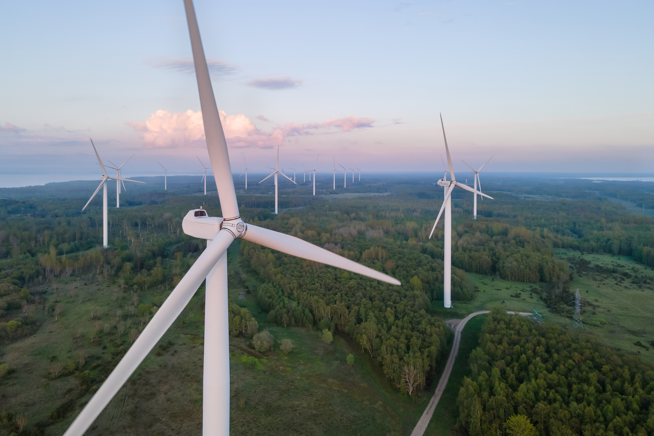 Wind turbines on sunset at summer evening. Renewable energy